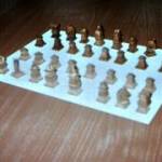 The PoW had hand carved these chess pieces. The darker set were possibly stained with blackberries, to give them their hue.