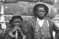 Four African-American boys, two holding sticks of sugar cane. Caroline, 1890s