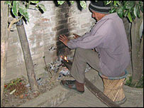 Nepalese man & his own form of central heating