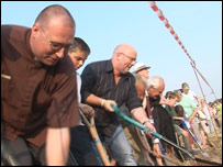 Jim Hawkins helps to cut the first sod