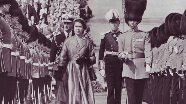Queen Elizabeth II inspects a line of the Irish Guards at Stormont, Northern Ireland, in 1953 (Popperfoto/Getty Images)