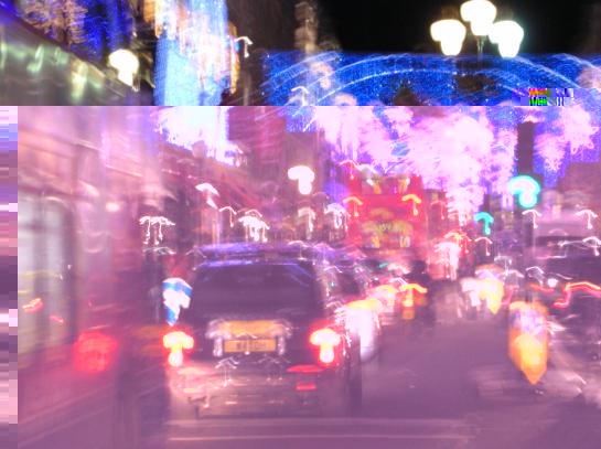 Christmas lights in Regent Street, with traditional black London taxis and red buses.