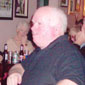 A Christmas party in Teac Mallon. Storyteller Jimmy Raferty sits at the front