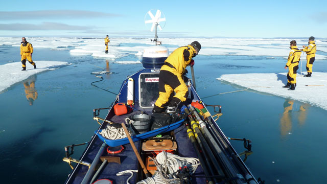 The crew take to the ice to get the boat to safety.