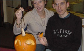Jonathan and Katie from the breakfast show making a pumpkin face and awarding the prizes