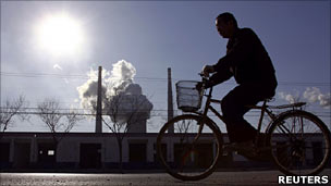 Man on bike outside Chinese factory