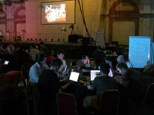 The Banana Labs team gather around a darkened desk at Hackday 2007 to create yet another mad app using BBC data.