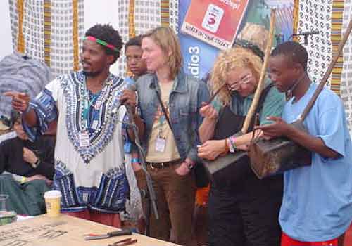 Risenga Makondo, World on your Street producer Tessa Watt and a brave volunteer join Sotho Sounds in a demonstration of their guitars made from scrap materials.