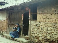 Chinese woman on the doorstep of her house