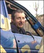 Andy Robertson in an old car