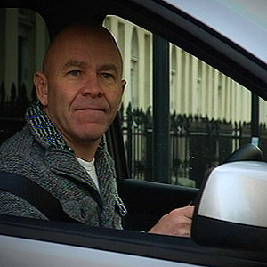 Dom Littlewood in a car