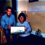 Ken Flowers and his wife Diane, holding a painting of HMS Achates done in oils, at their home in Bristol.