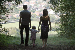 Picture shows couple and child in rural scene