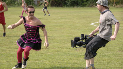 Bruce playing football in his drag outfit