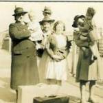 (L to R) Nurse Richards Jones holding Anne, Mr Williams, Mrs Thomas and Lily, her daughter, Mum carrying David. Waiting at Ferryside for the train to Birmingham.
