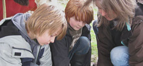 family taking part in an archaeological dig
