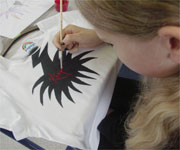 A young person creating a graffiti t-shirt