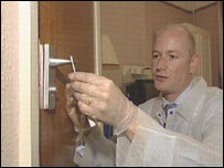 Jim Francis taking swab test on door handle