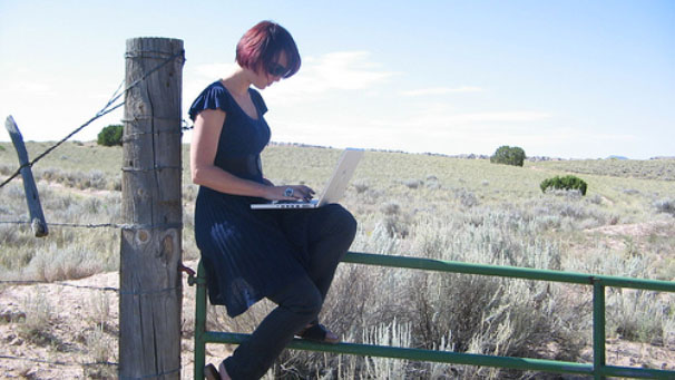 Aleks Krotoski on her own in the New Mexico desert, using a laptop