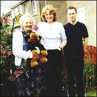 Brenda Carlisle in the middle with her family 2002
