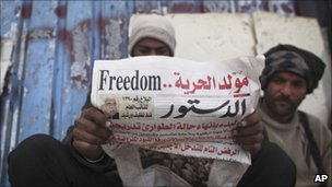 Protester reading newspaper in Tahrir Square