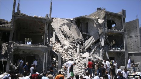 The rubble of a residential building in Tripoli which the Libyan authorities say was hit by a Nato air strike in June 2011