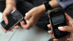 Two people using smartphones