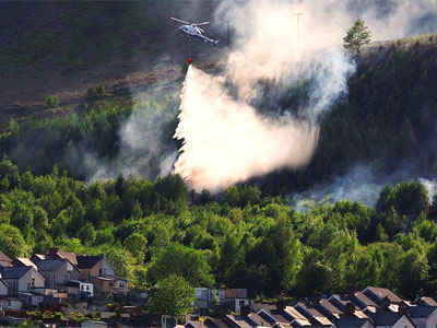 Retired firefighter, Gerwyn Gibbs took this amazing photo of a helicopter dousing the fire near Mountain Ash with water yesterday.