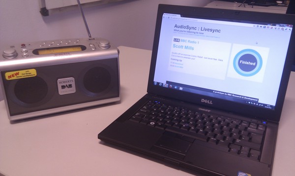 A photo of the AudioSync application running on a laptop next to a radio.