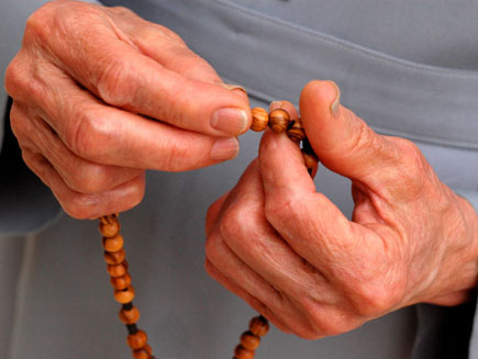 Nun holding wooden rosary