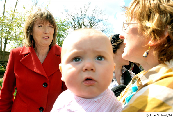 Harriet Harman talks to women with children in the garden of Vestry House Museum in Walthamstow