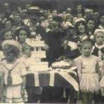 'Old Mother Rielly and Kitty' Terry Darlow right foreground with dog Floss at VE Day street party