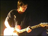 Simon plays the guitar