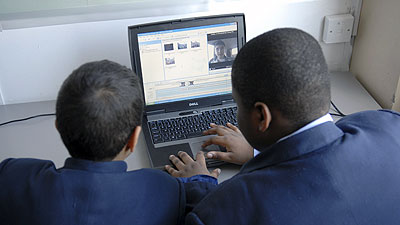 Schoolchildren using a computer at a, a secondary school in London