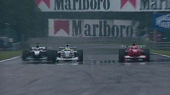 McLaren's Mika Hakkinen (left) overtakes the Ferrari of Michael Schumacher (right) as they lap the BAR of Ricardo Zonta at the 2000 Belgian Grand Prix