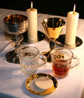 Wine cup, candles and wafers for the ceremony of the Eucharist