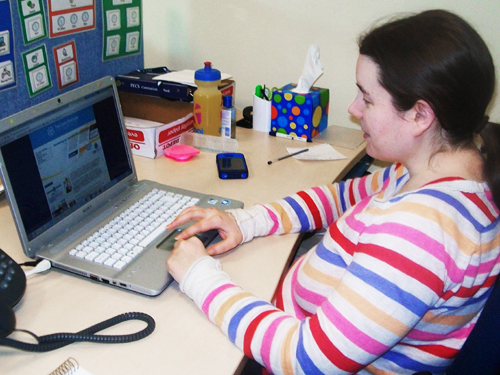 Alex Jordan typing on a laptop