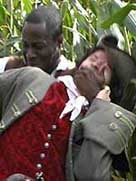 Historical reconstruction showing a black slave man attacking a white man