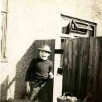Derek Pearson aged 9 showing gap in the fence for the neighbours