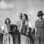 This picture is of my friend Lilian aged 14 and me at 16 in our Swiss workday costumes. The older people are Lilian’s mother and father.