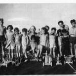 The ship's chippy with the children from POW Camps and the toys that he made for them