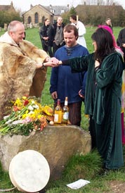 Male and female druids performing a marriage ceremony for a couple at Avebury stone circle