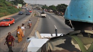 UN soldier driving down a main road in an armoured vehicle