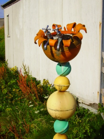 Two taps in an art feature at Berneray Harbour