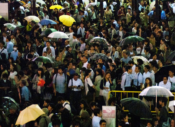 a sea of umbrellas outside Shibuya station