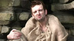 Maggot sitting in a cave wearing sackcloth