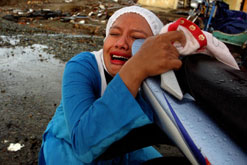 Image: A distraught mother in Banda Aceh returns to the spot where her child was washed away in the Tsunami