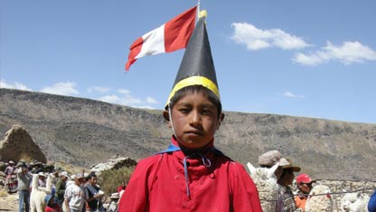A boy wearing a Quechua costume for the children's dances