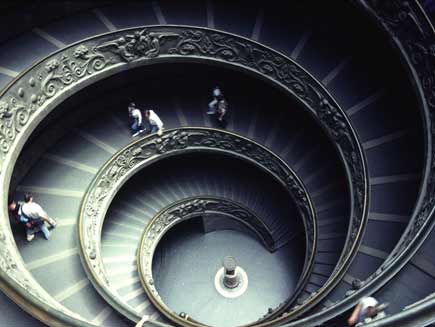 Twin interleaved spiralling staircases with broad steps and carvings on the outside walls
