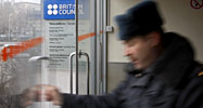 A Russian police officer leaves the British Council office in Moscow